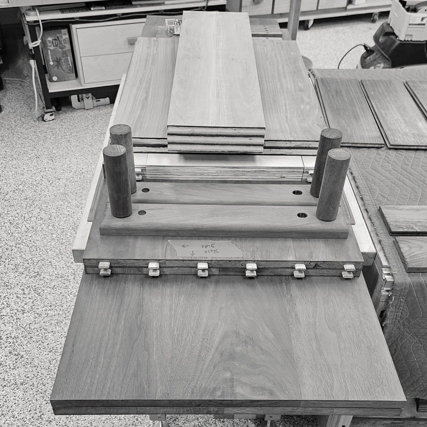 Walnut furniture components arranged on a workbench
