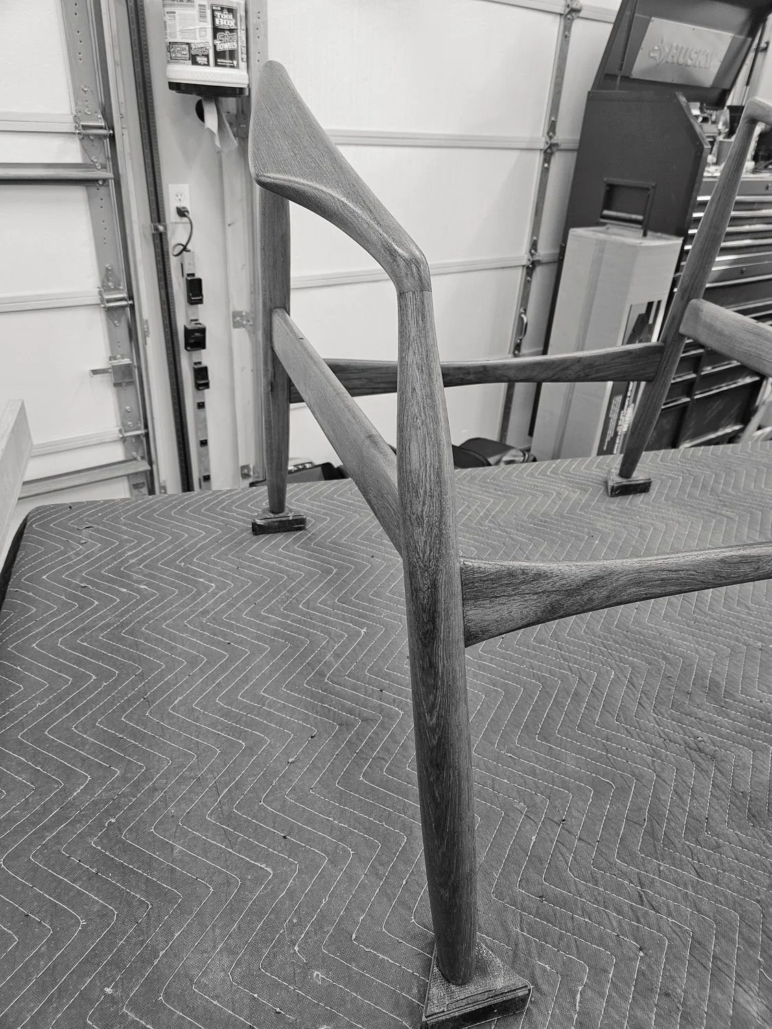 Close-up of the sculpted teak arm and frame of the Seal lounge chair (Copy) (Copy) (Copy) (Copy)