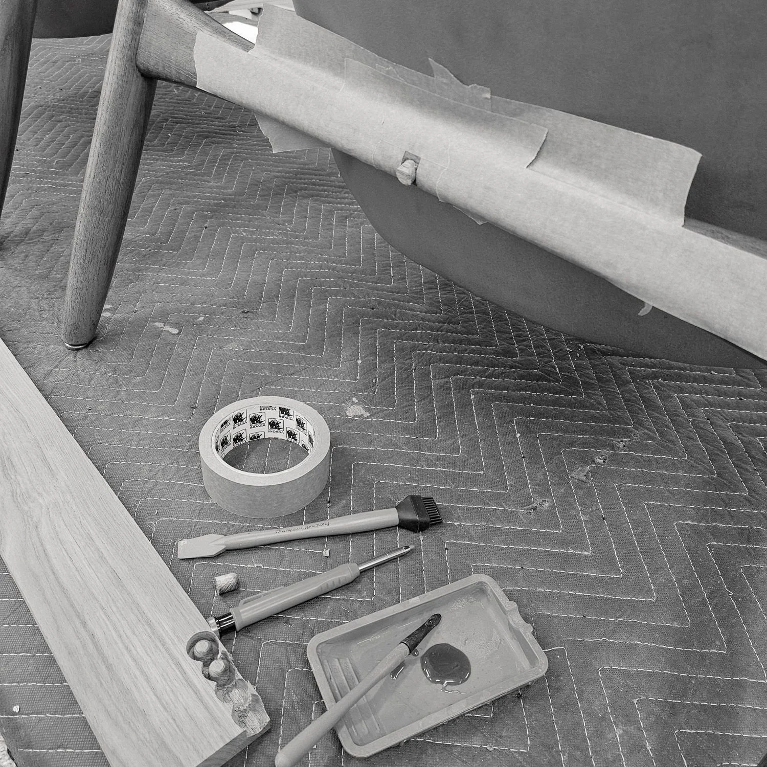 Close-up of a taped repair area on the teak frame during restoration (Copy) (Copy) (Copy) (Copy)