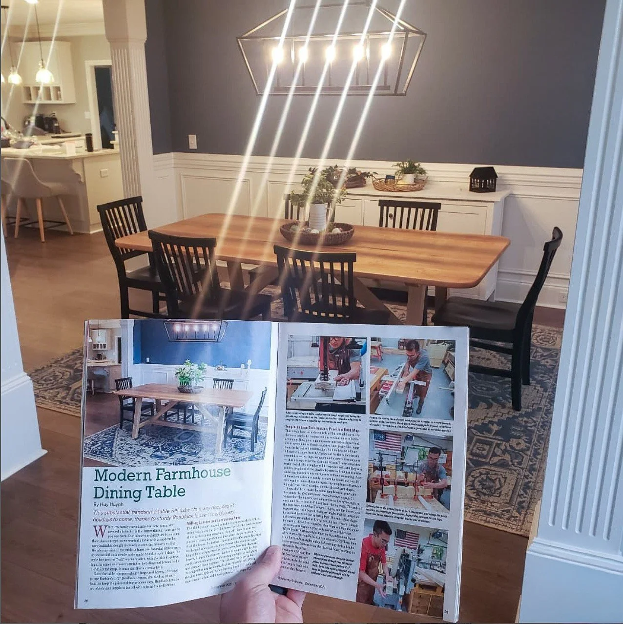 Woodworker’s Journal article about the Modern Farmhouse Dining Table held in front of the finished table.