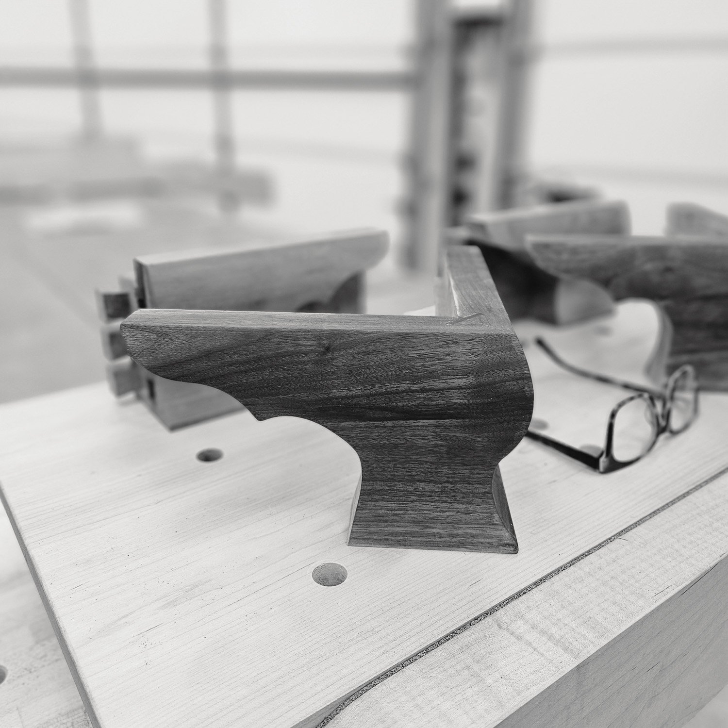 Sculpted walnut ogee bracket foot being shaped during construction of the Masterworks china cabinet.