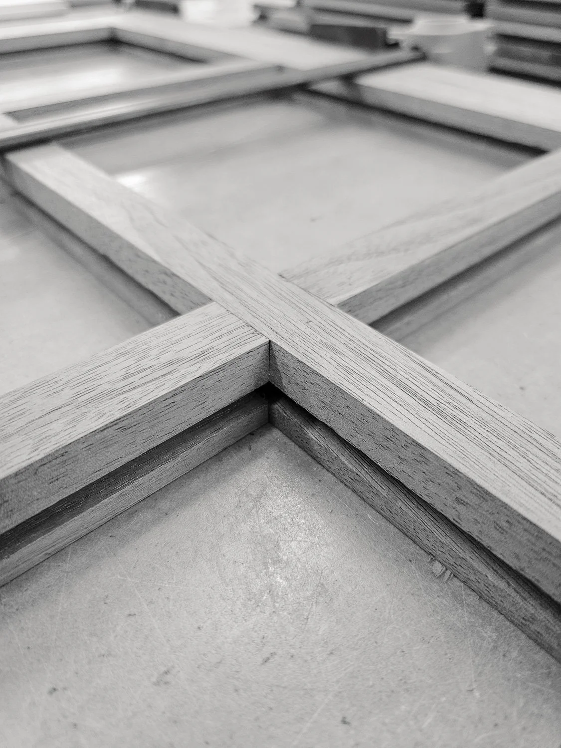 Walnut divided-light door frame laid out in the workshop during construction of the Masterworks china cabinet.