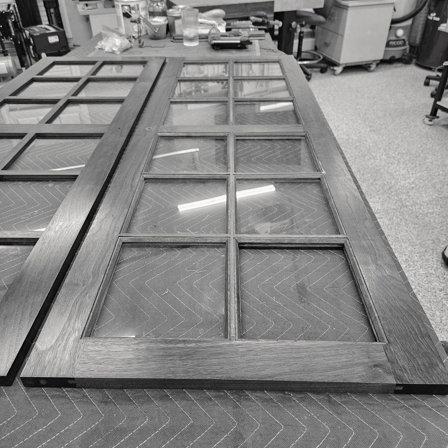 Walnut twelve-lite cabinet door fitted with glass panels during construction of the Masterworks china cabinet.