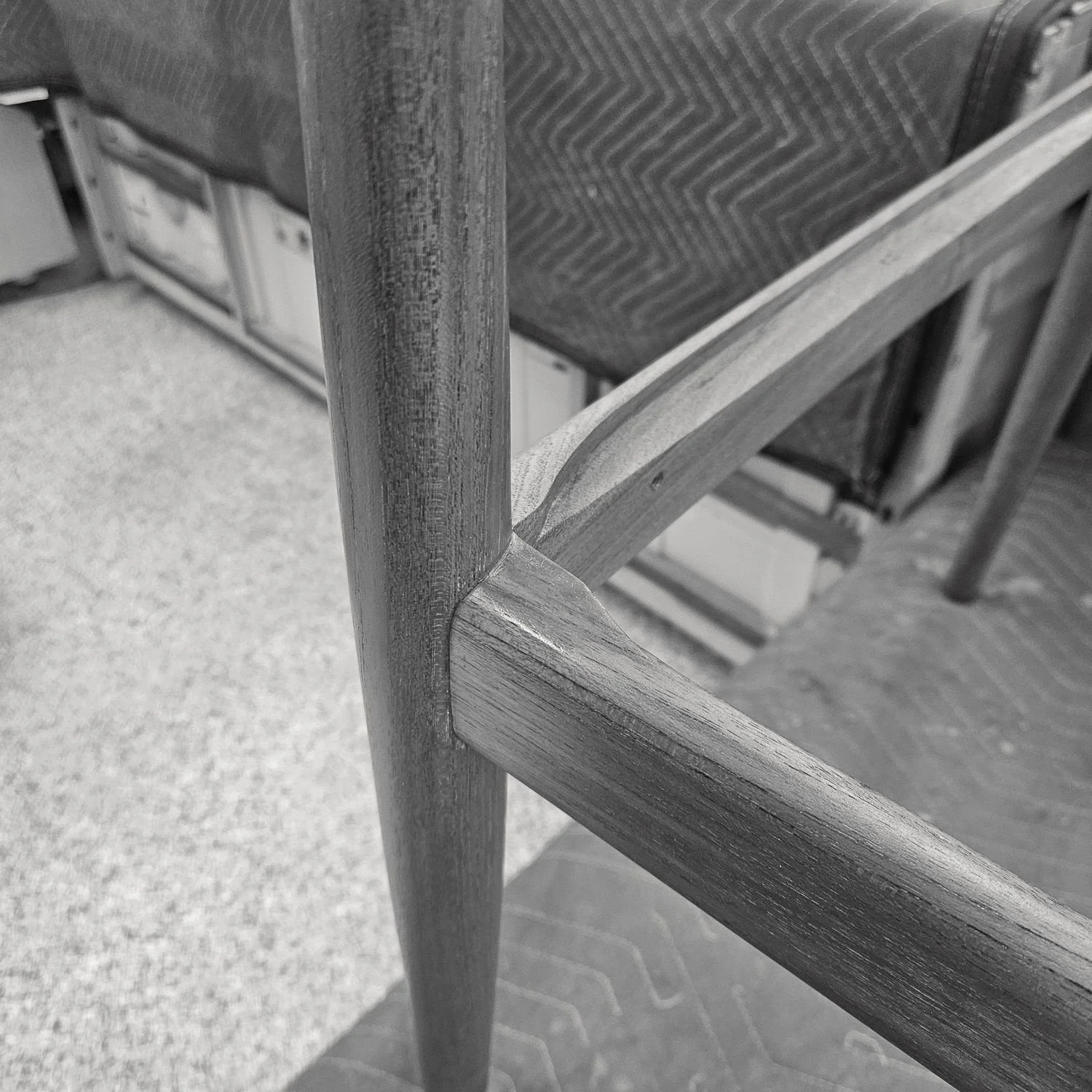 Close-up of a restored teak frame joint on the Hans J. Wegner JH 503 chair.
