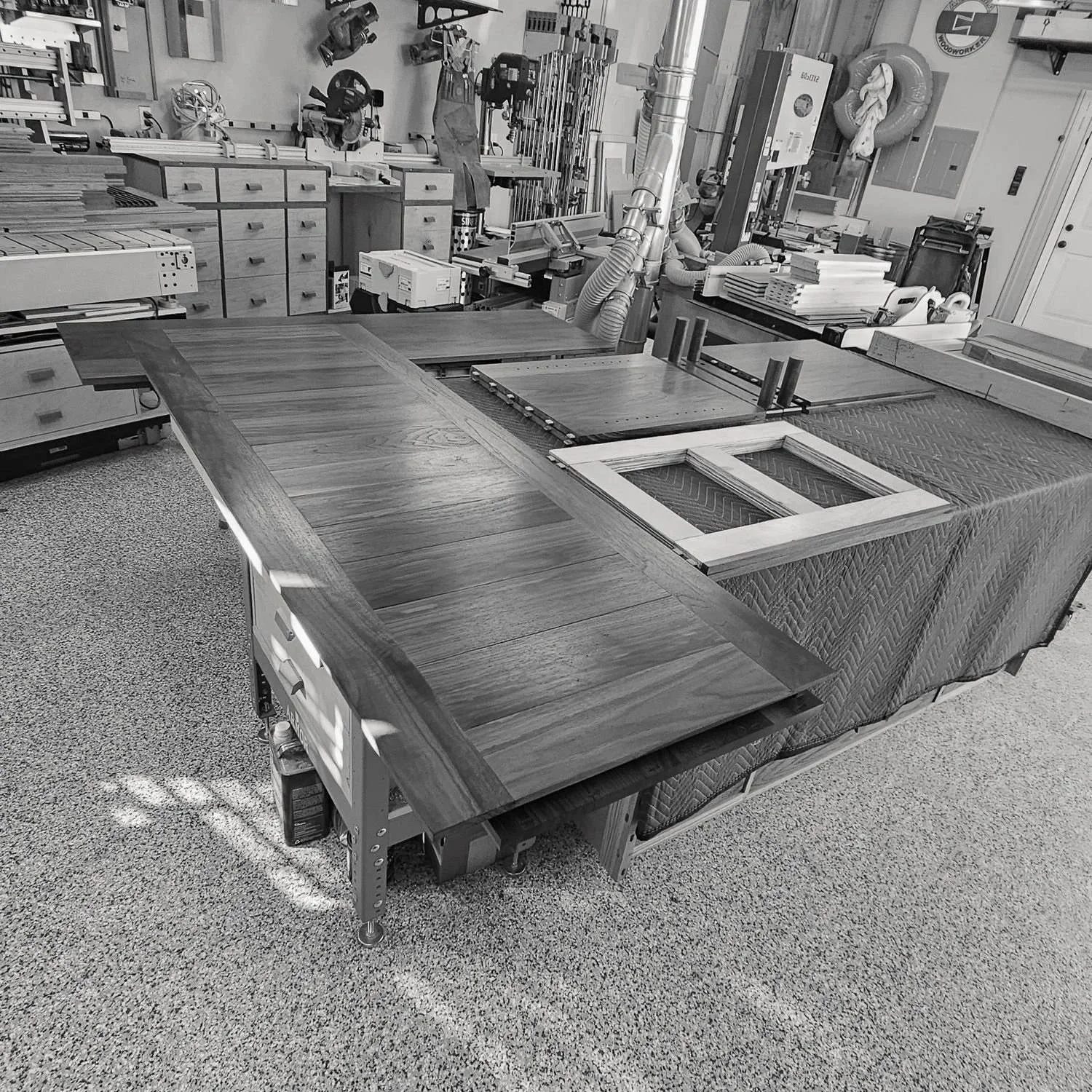 Walnut sideboard components arranged in the workshop