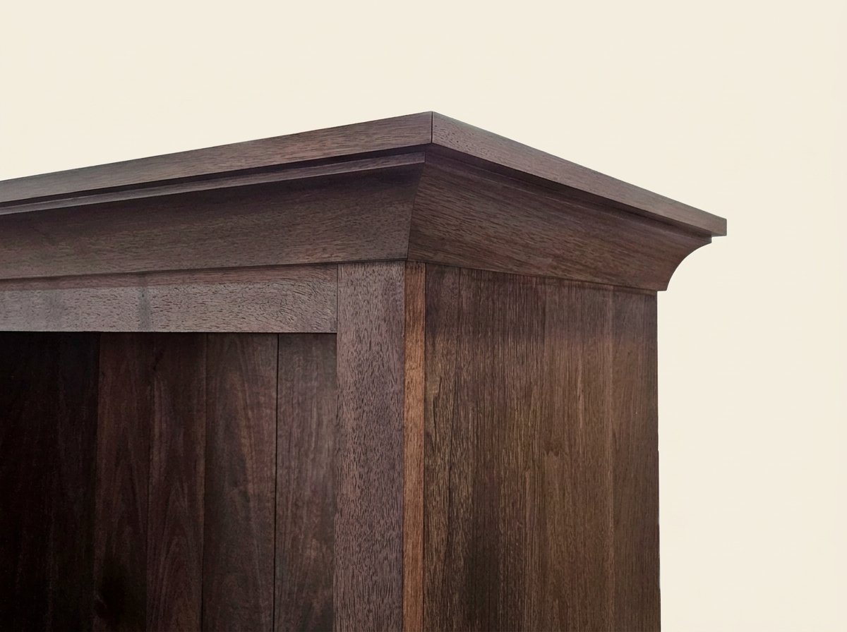 Close-up of the upper crown molding and walnut side panel on the handmade Masterworks china cabinet.
