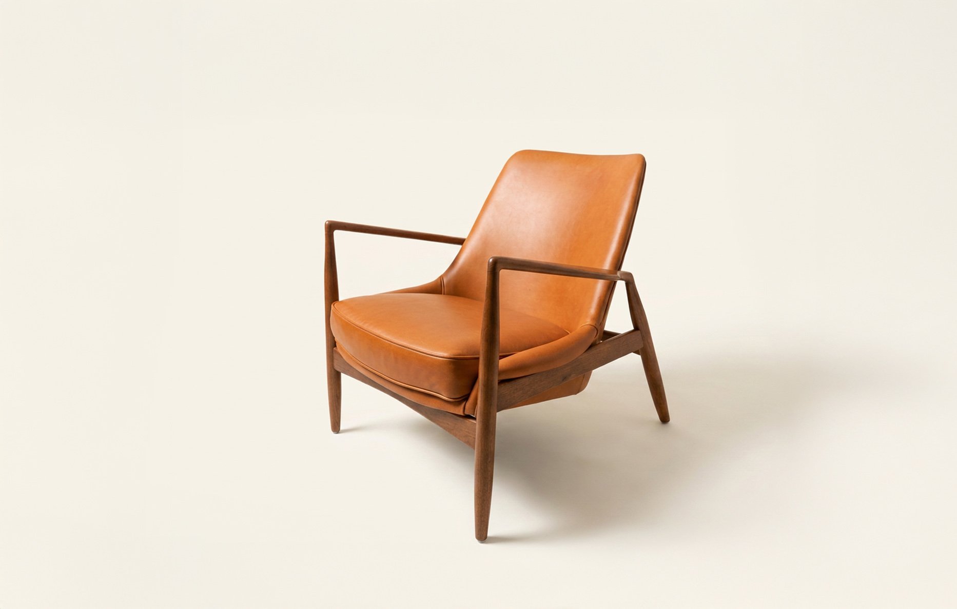 Ib Kofod-Larsen “Seal” lounge chair with cognac leather upholstery