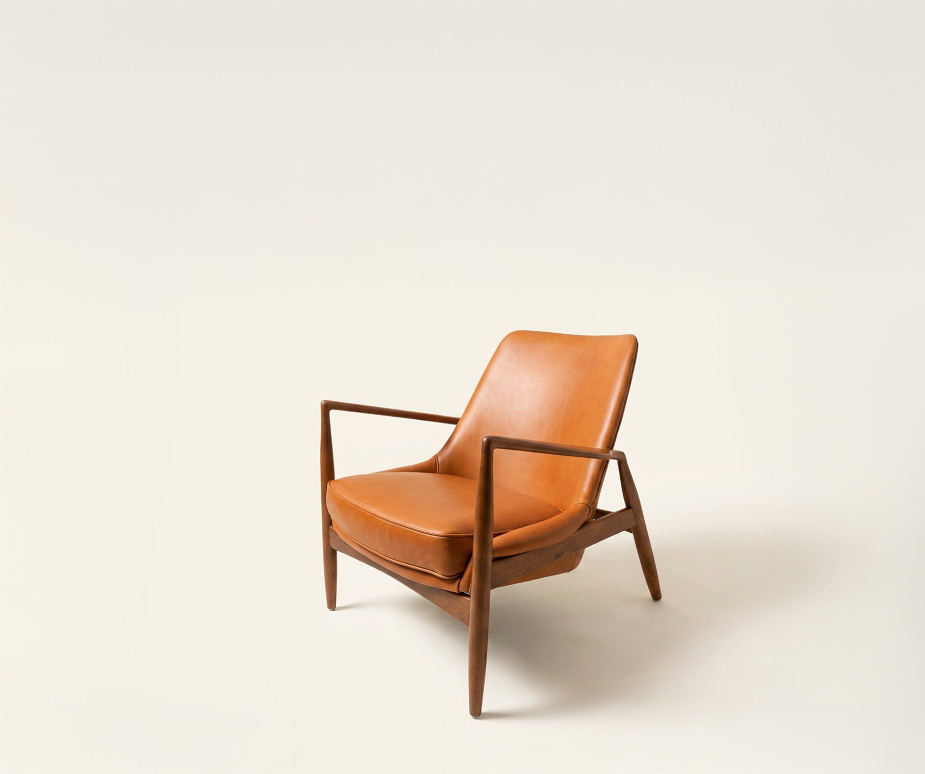 Ib Kofod-Larsen “Seal” lounge chair with cognac leather upholstery