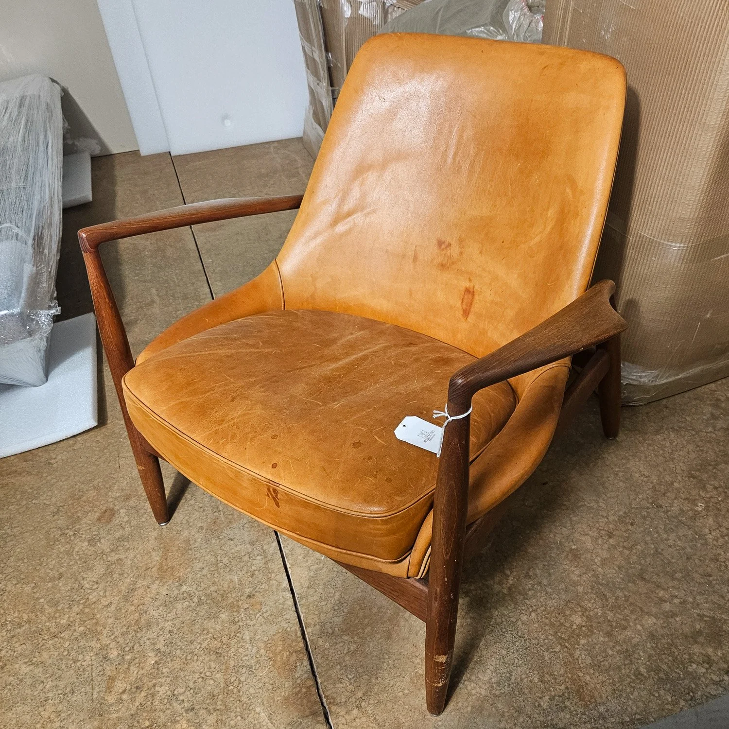 Vintage lounge chair with visible wear before condition assessment