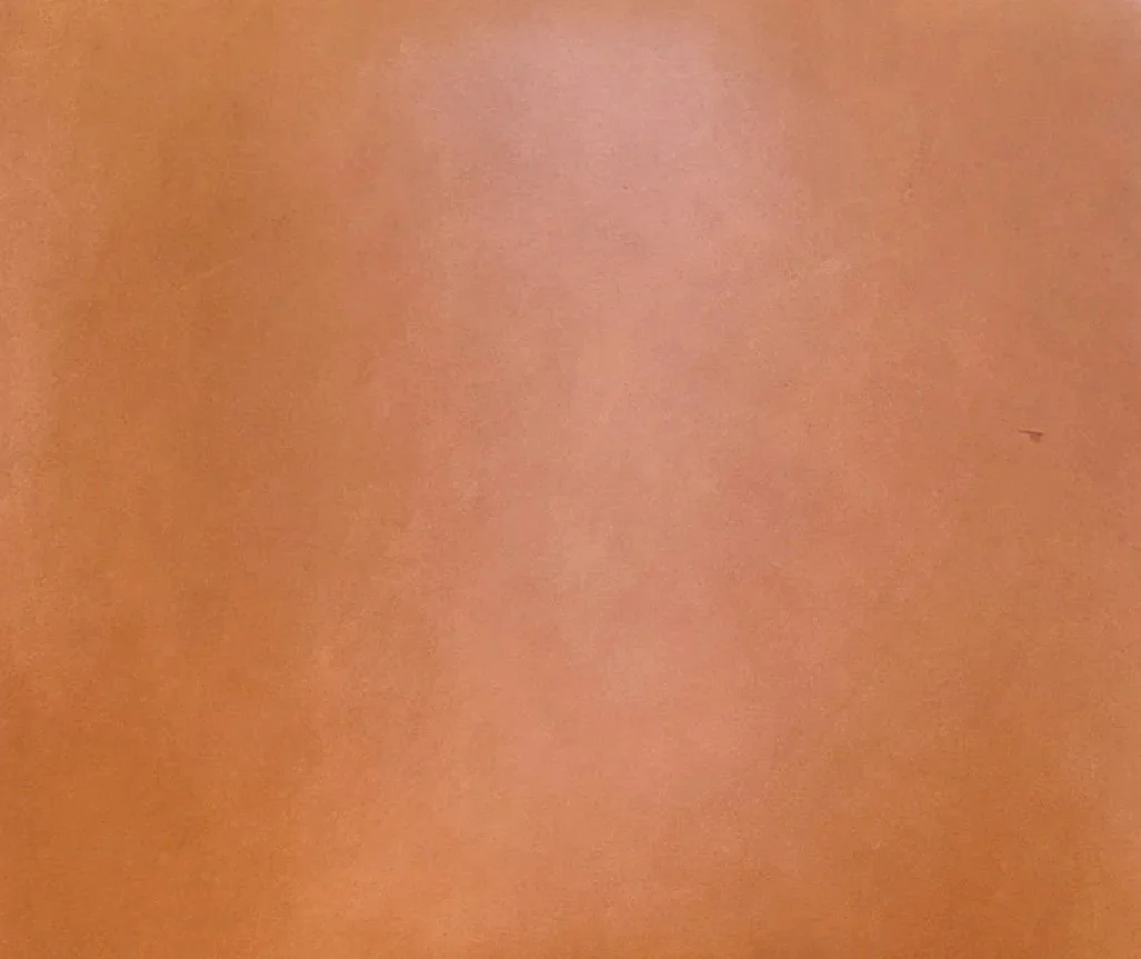 A close-up detail of the Cognac leather upholstered shell from the restored Ib Kofod-Larsen "Seal" Lounge Chair