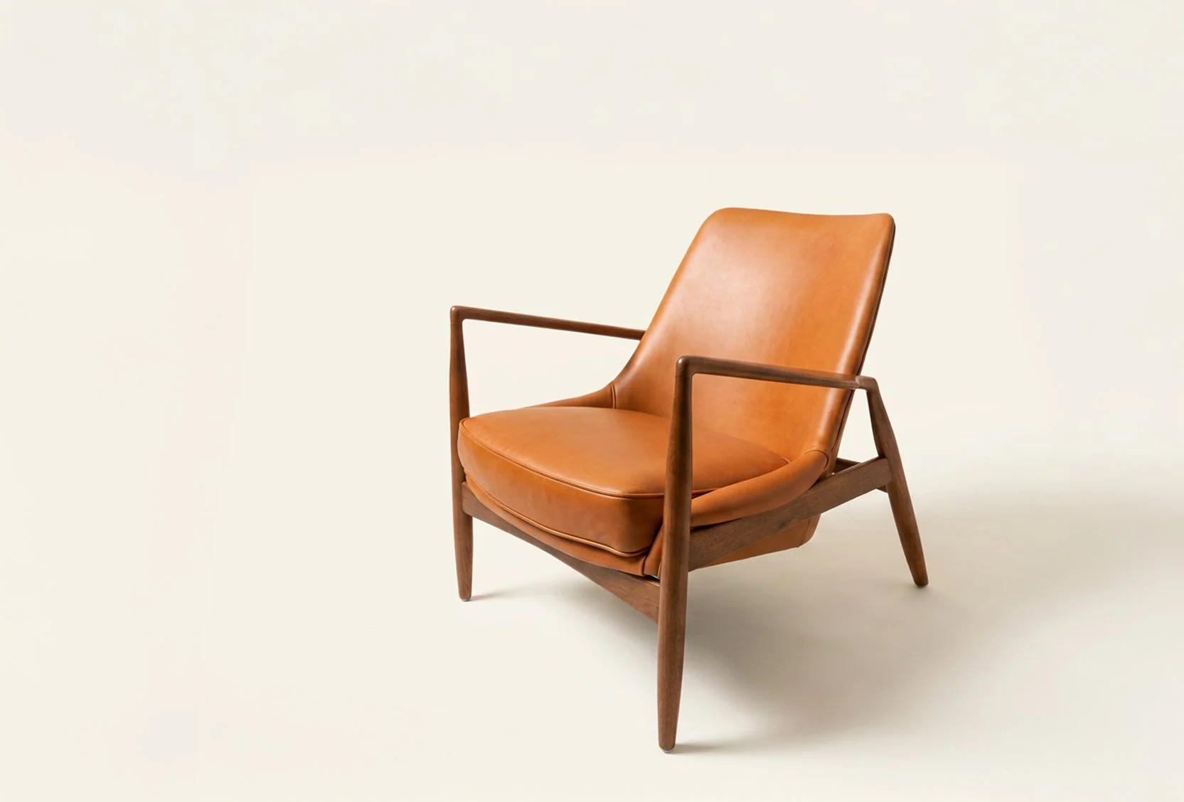 Ib Kofod-Larsen “Seal” lounge chair with cognac leather upholstery