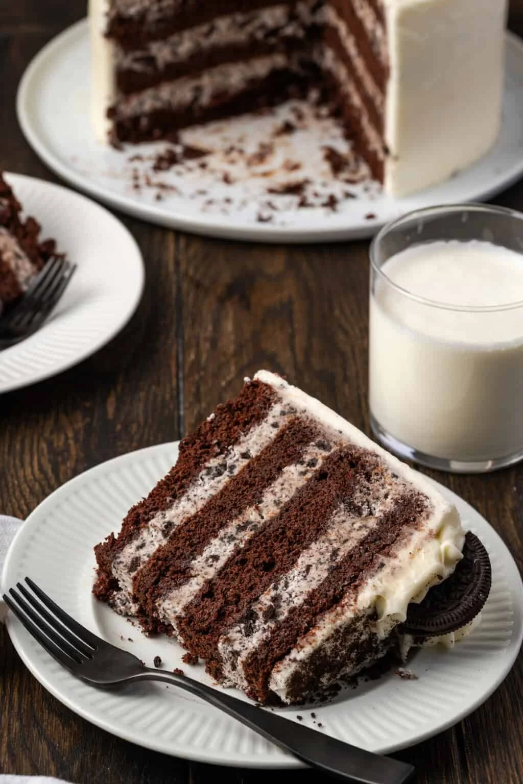 A slice of cookies & cream cake with buttercream frosting.