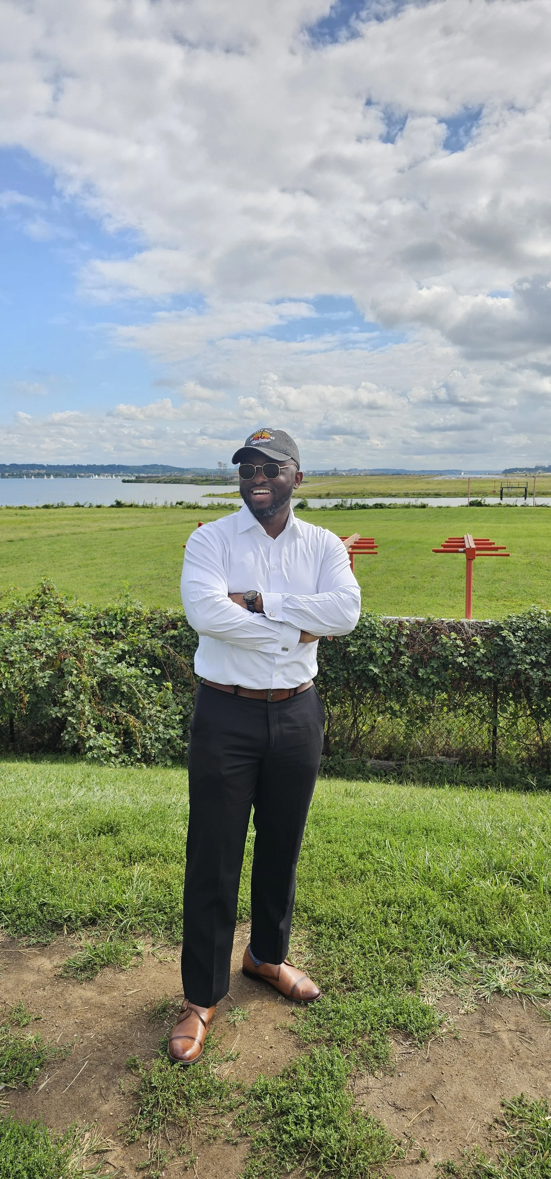 Portrait of the bakedbyAma baker standing outdoors by the waterfront.