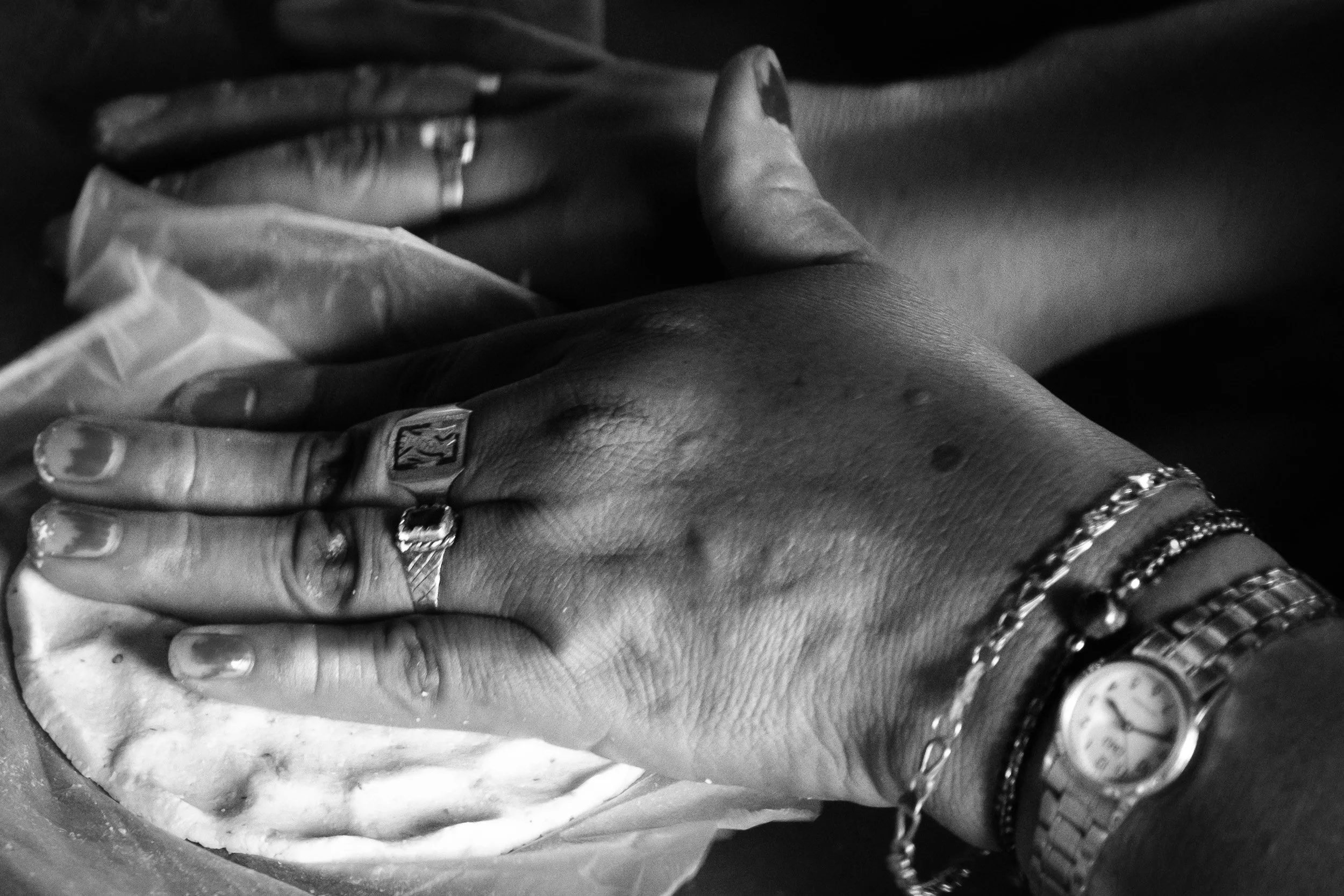 Black and white fine art photograph from From Land to Sea by Tommy (Thomas) Salpietro, depicting the hands of a Maya community member making traditional tortillas in the Yucatán Peninsula, Mexico.