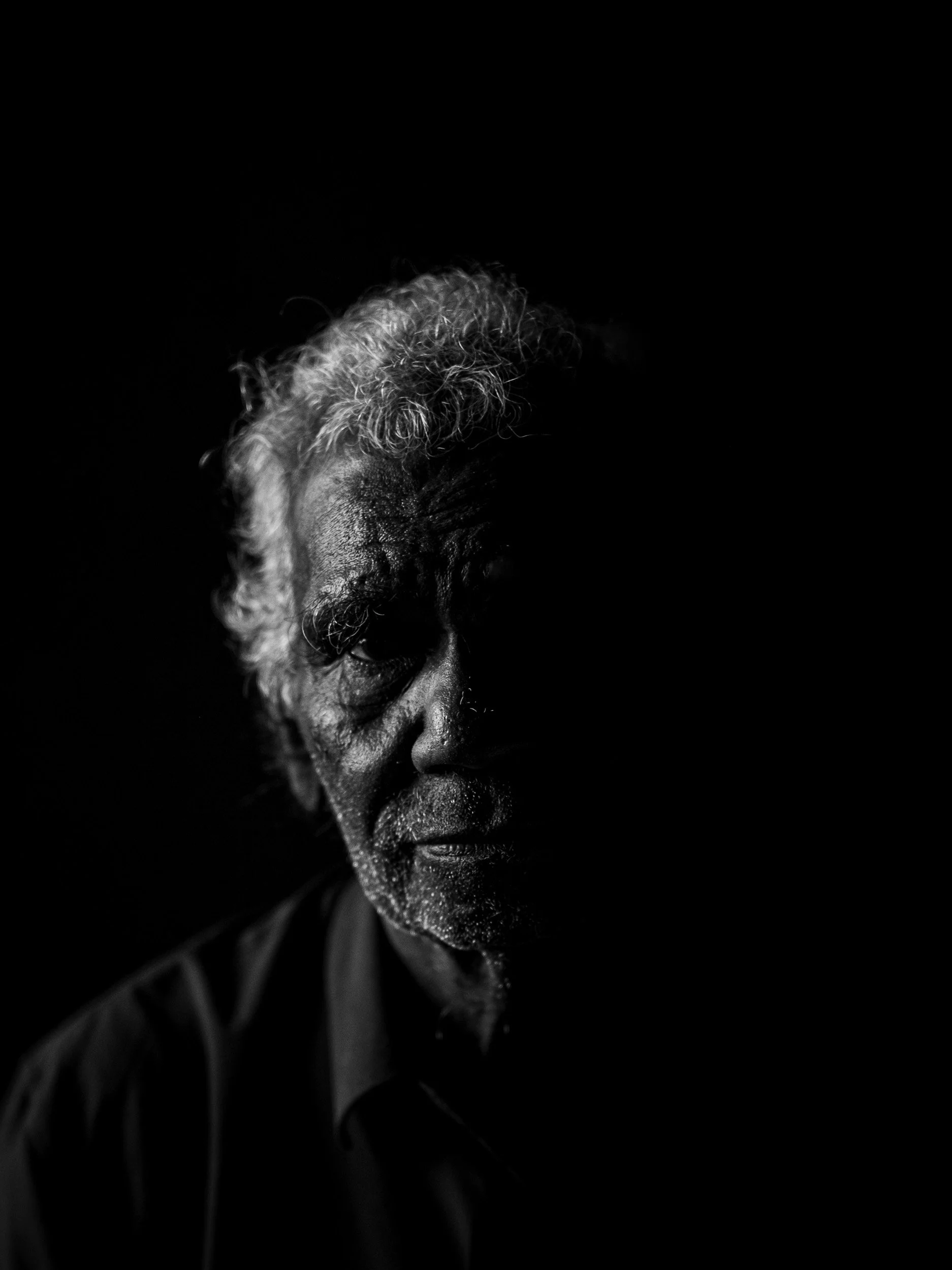 Black and white fine art portrait from From Land to Sea by Tommy (Thomas) Salpietro, depicting a Kuku Yalanji Elder. Documentary photography exploring Indigenous Australian culture, knowledge, identity and tradition.