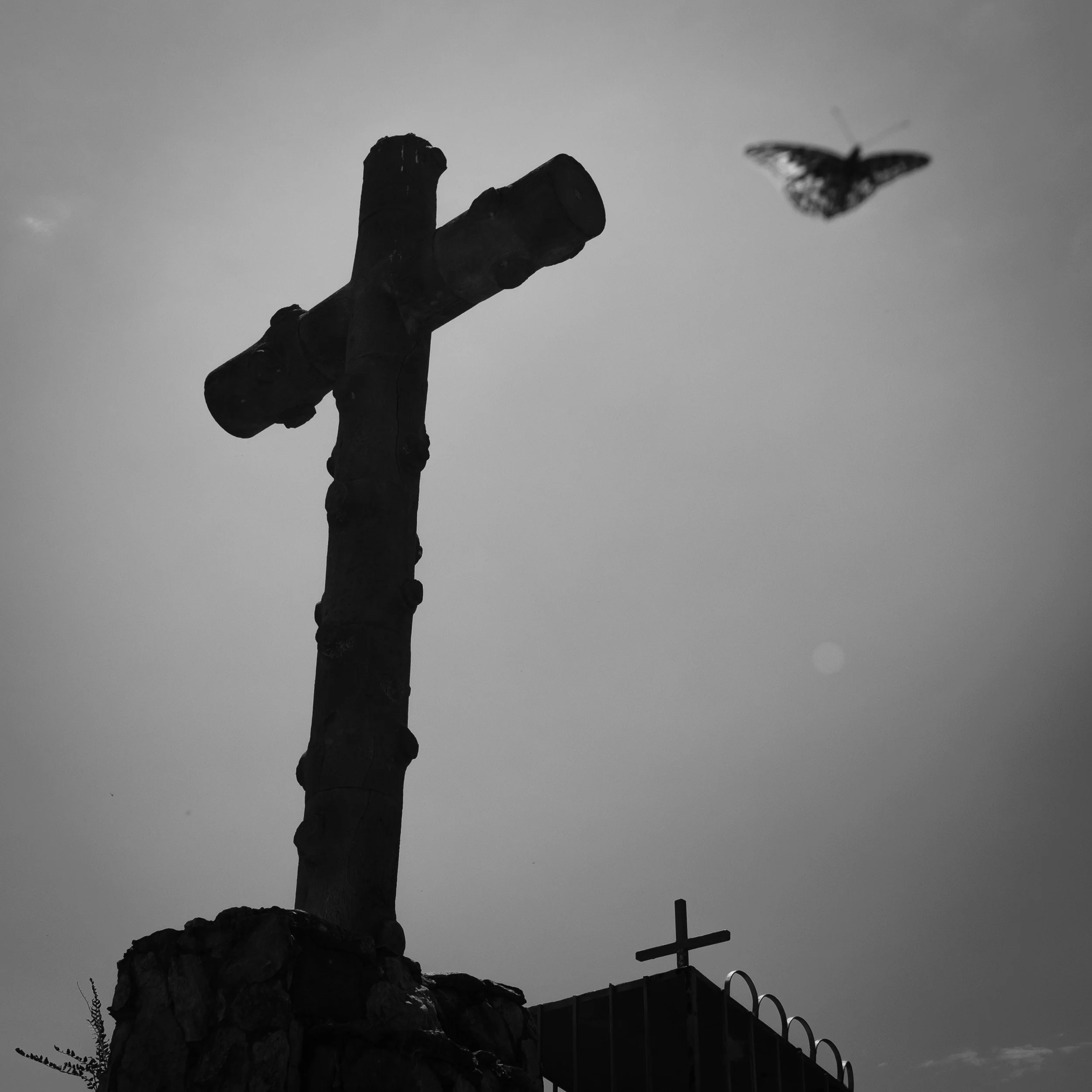 Black and white fine art photograph from Tierra de Silencio by Tommy (Thomas) Salpietro, depicting a Catholic cross in rural Mexico, exploring faith, devotion and tradition.