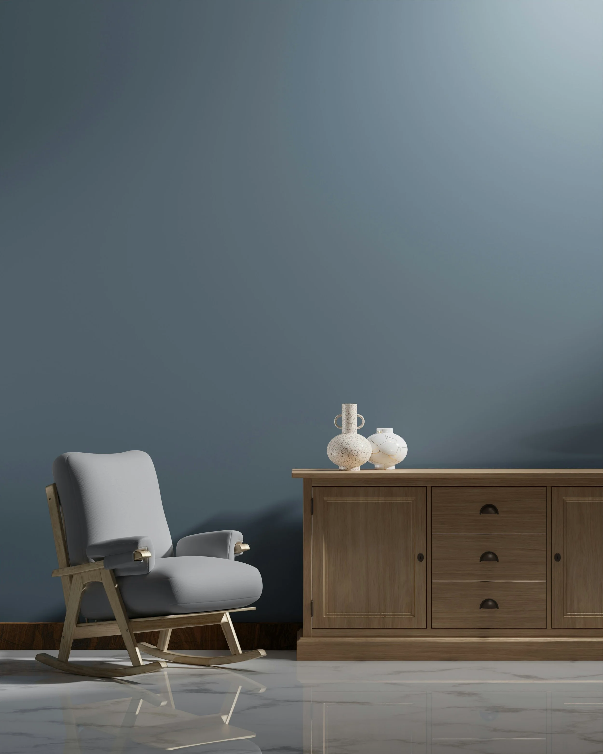 A minimalistic interior with a white modern rocking chair and a wooden sideboard with decorative vases on top, against a dark grey wall and white marble floor.