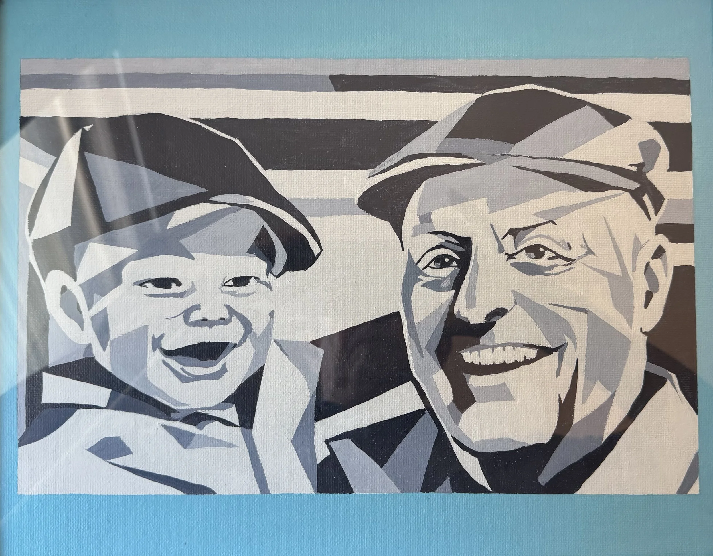 A black, white, and gray abstract portrait of two smiling individuals, grandson and grandfather,against a light blue background.