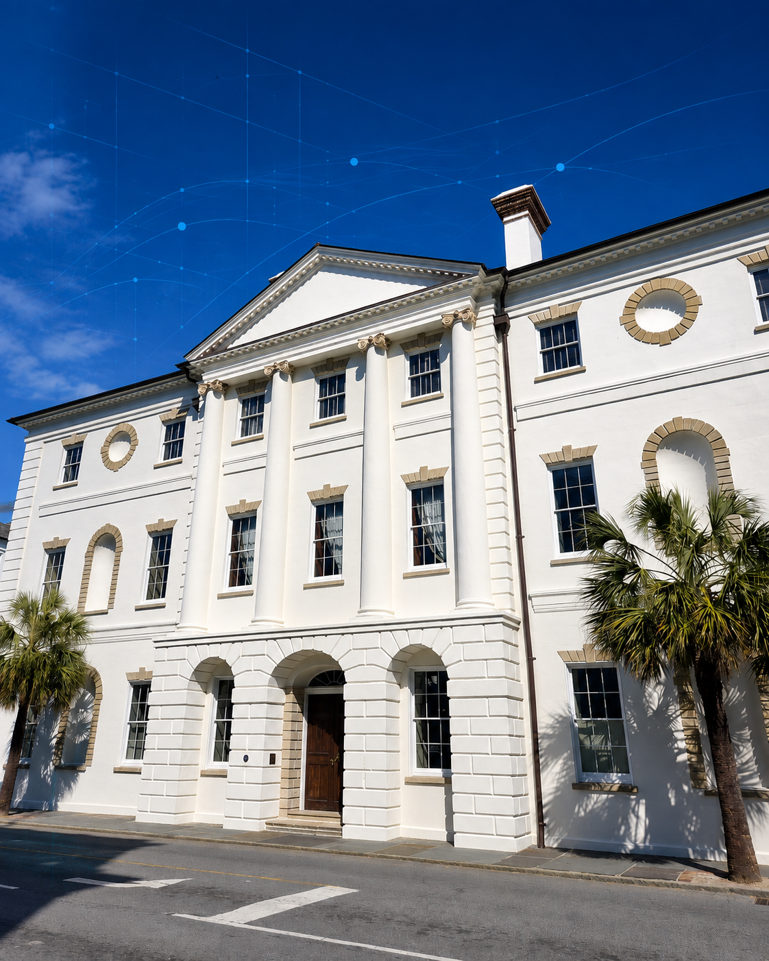 White neoclassical building with columns and arched windows, palm trees, blue sky with digital network graphic overlay. Charleston SC Courthouse