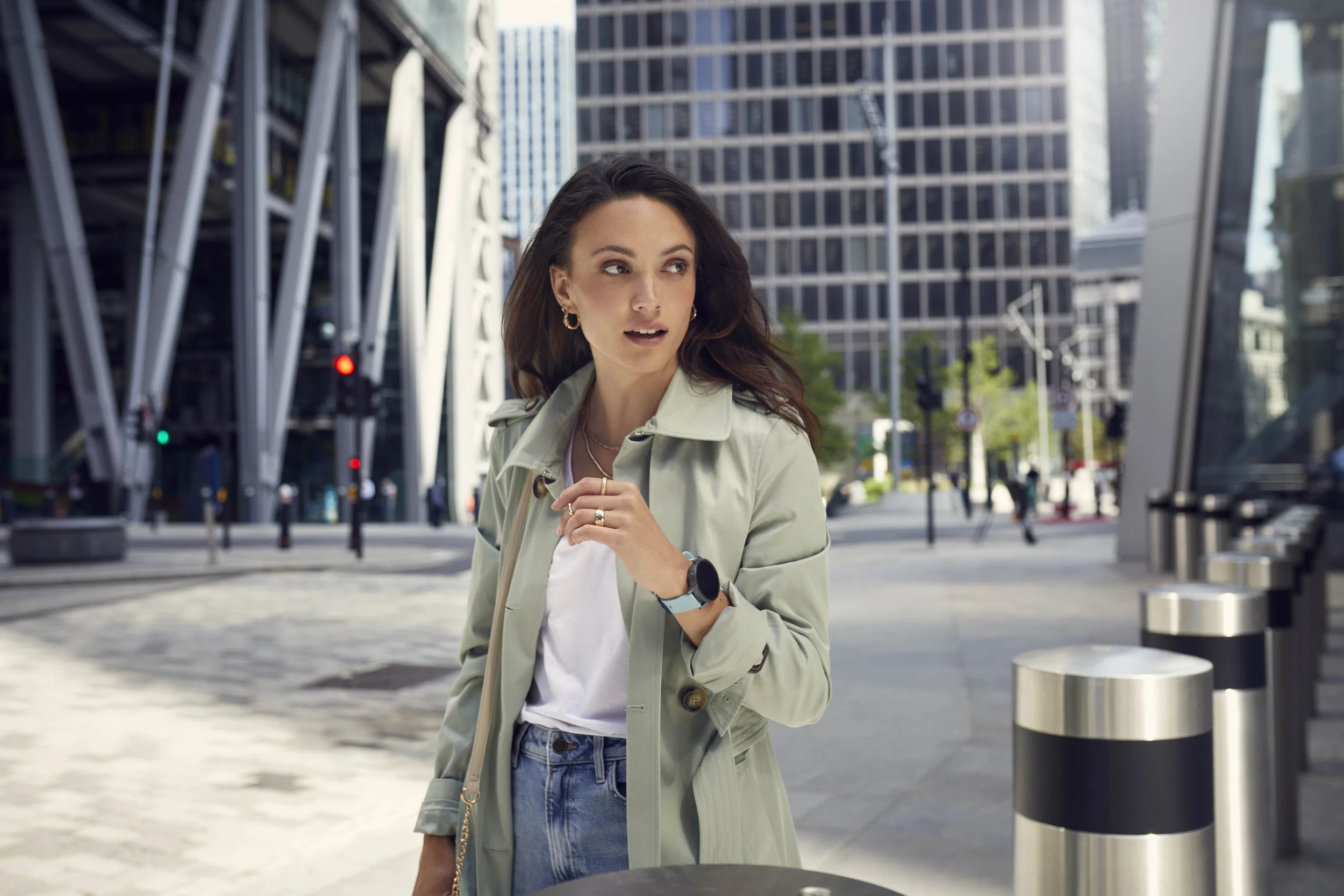 A young women walk through the busy of London, glancing at her smartwatch in this lifestyle image taken by photographer Jon Enoch.