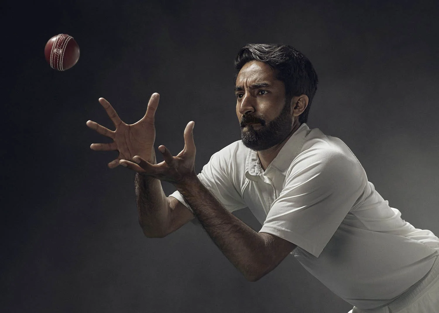 A cricketer goes to catch the ball in this sports photography from sports, advertising and lifestyle photographer Jon Enoch