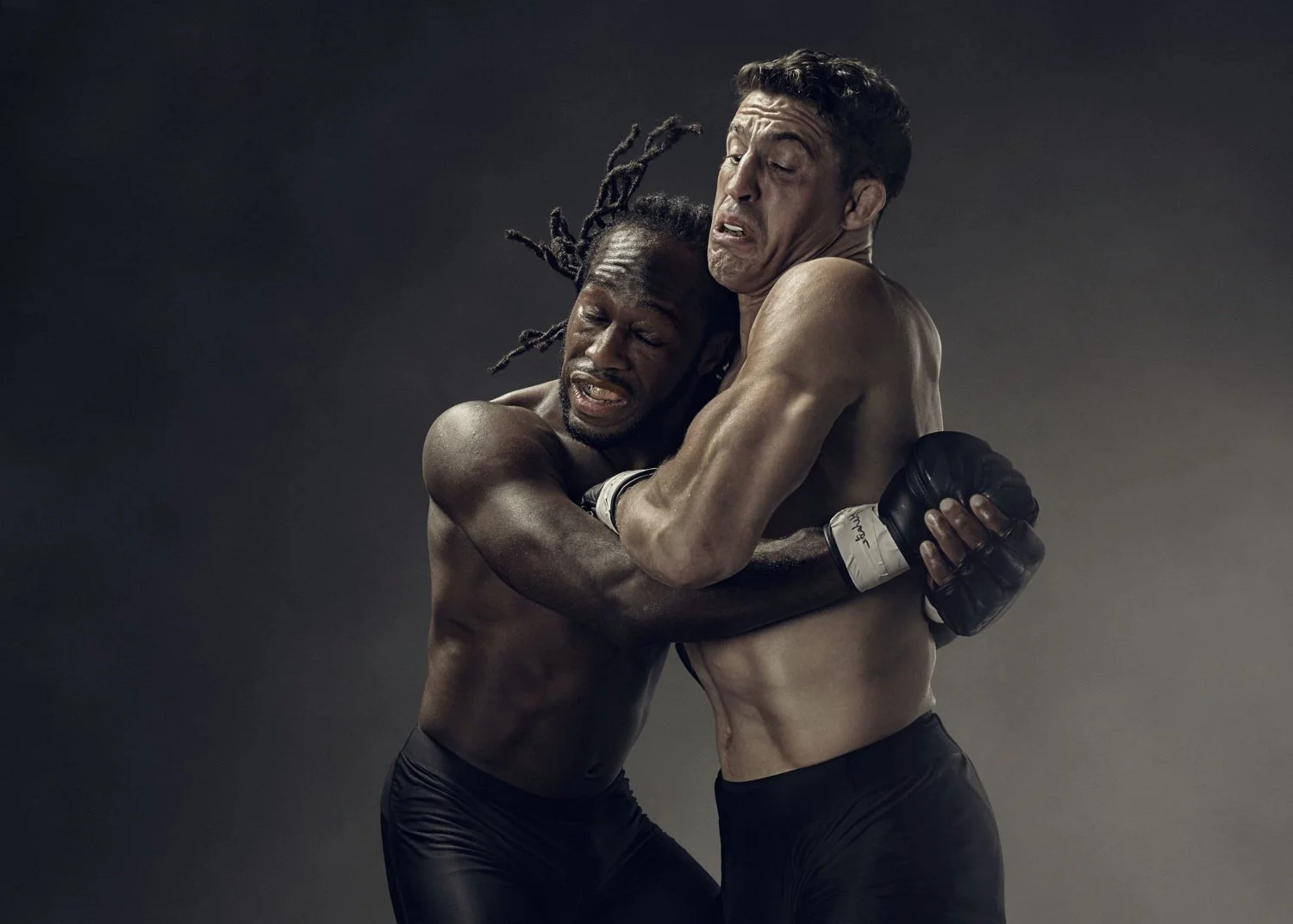 Two MMA fighters are locked in battle in the sports photography action shot from advertising photographer Jon Enoch
