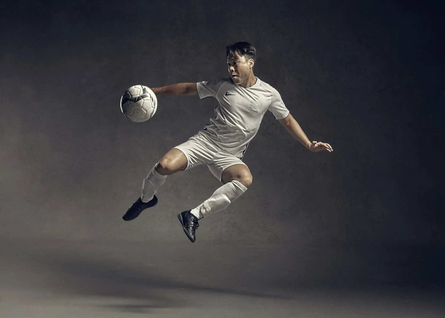 sports photographer Jon Enoch's image of a footballer jumping in the air to volley a ball