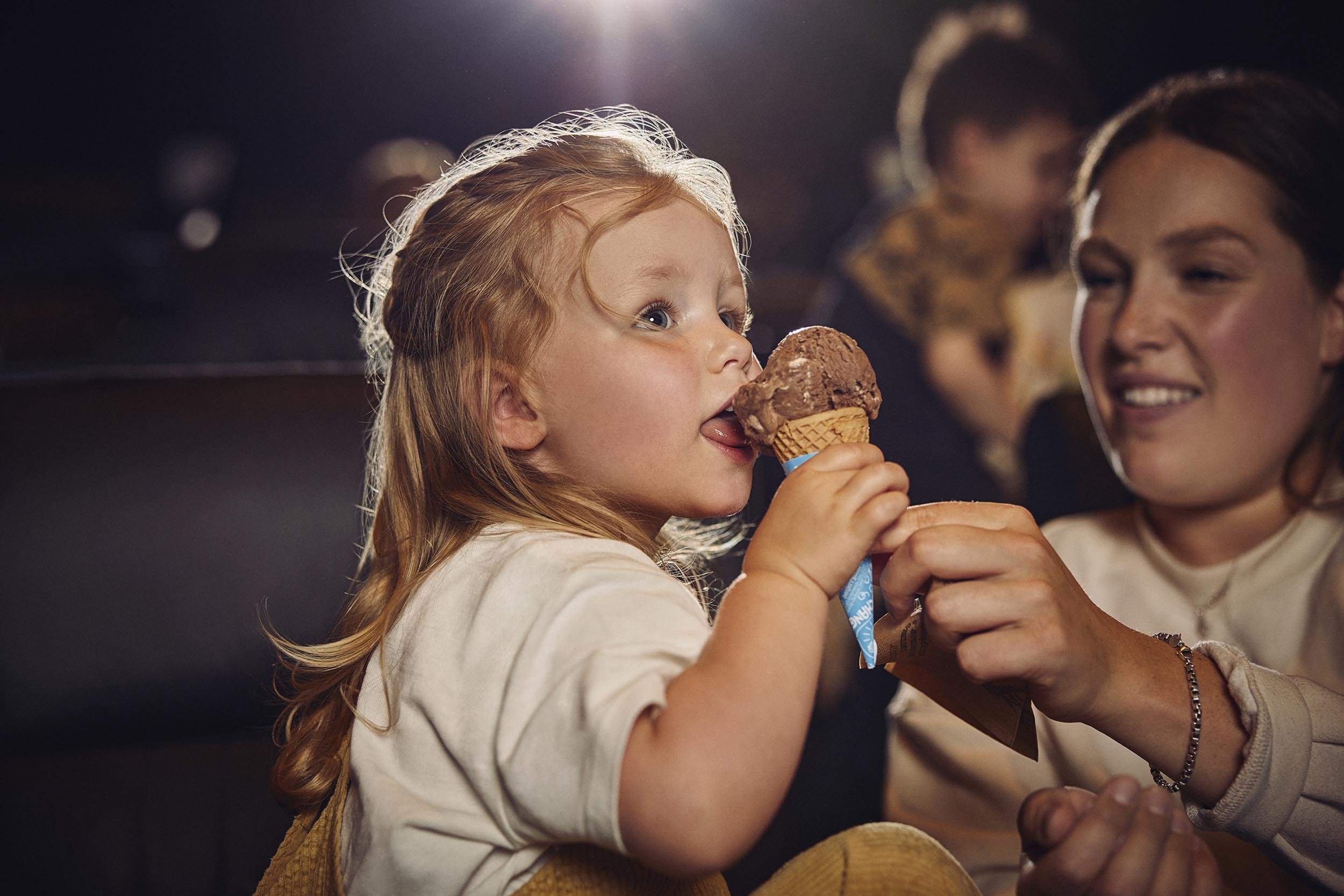 A child easts an ice cream in this lifestyle photography by advertising photographer Jon Enoch for leading cinema chain Vue