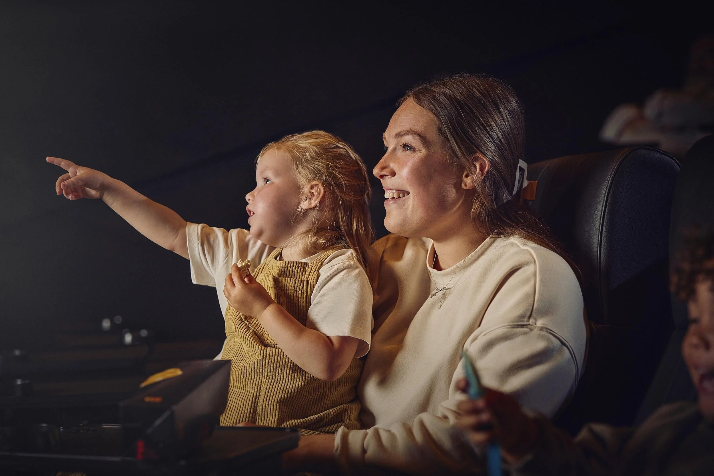 A mother and daughter enjoy a film at a Vue cinema in this family lifestyle image by london based photographer Jon Enoch