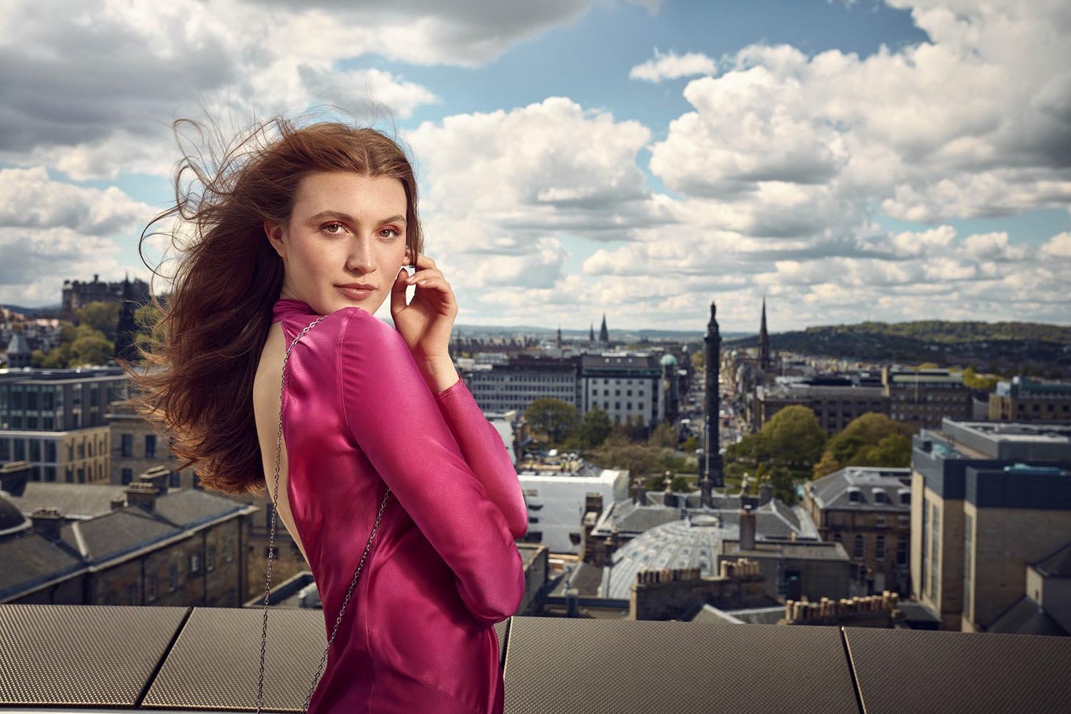 A women stands on a rooftop over looking Edinburgh. Advertising lifestyle images for St.James in Edinburgh. St.James' is a shopping retail centre. Jon Enoch's images will be used to promote the centre across the country.