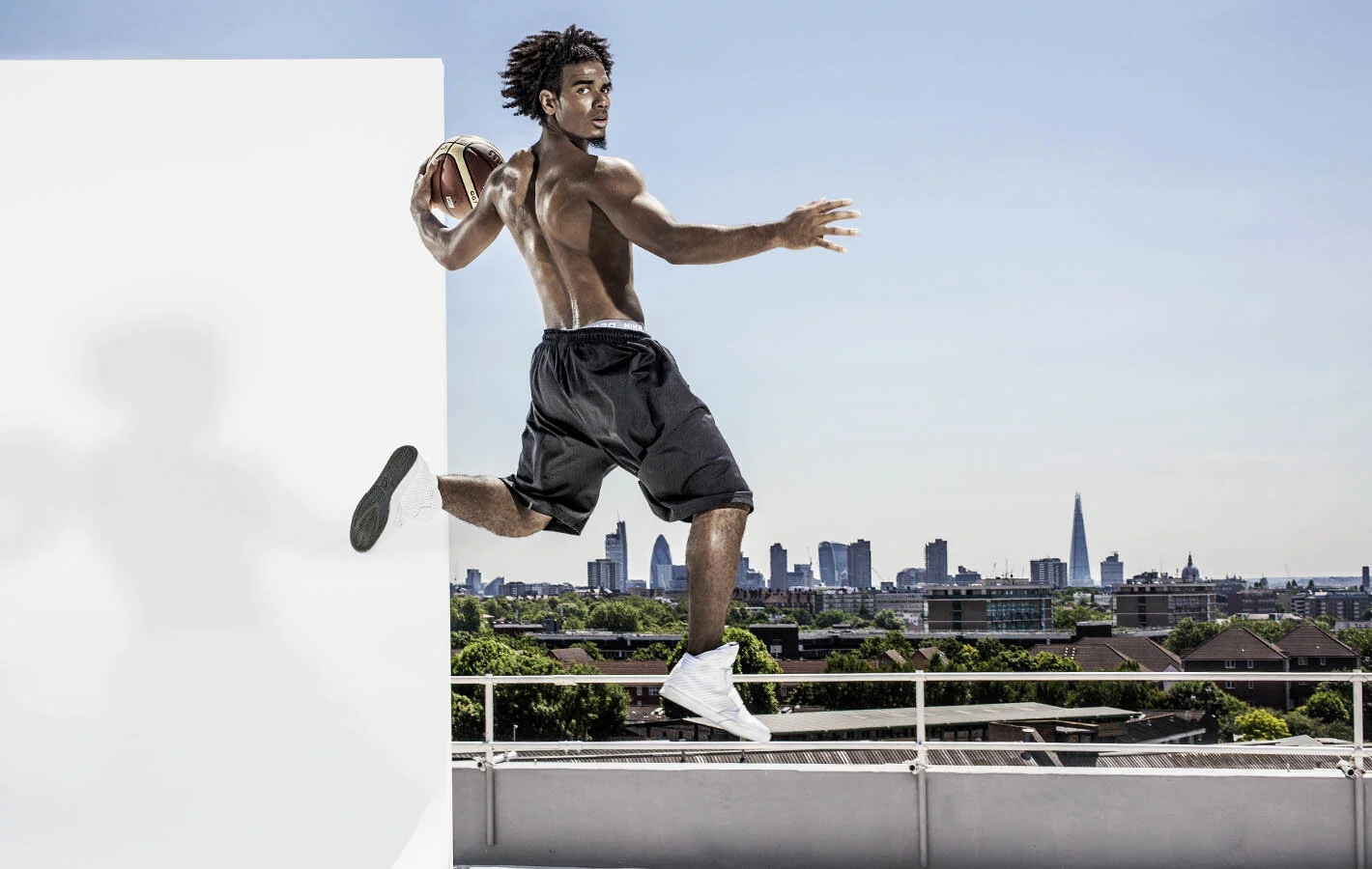 A man leaps across the London skyline with a basketball in this dramatic image from sports lifestyle and advertising photographer Jon Enoch  (Copy)