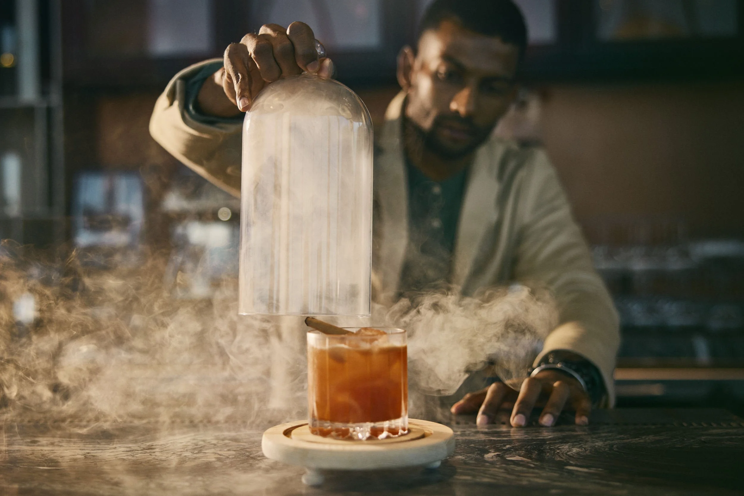 A barman finishes a cocktail in this lifestyle image shot for the Saudi Neom project featuring their Red Sea luxury holiday island