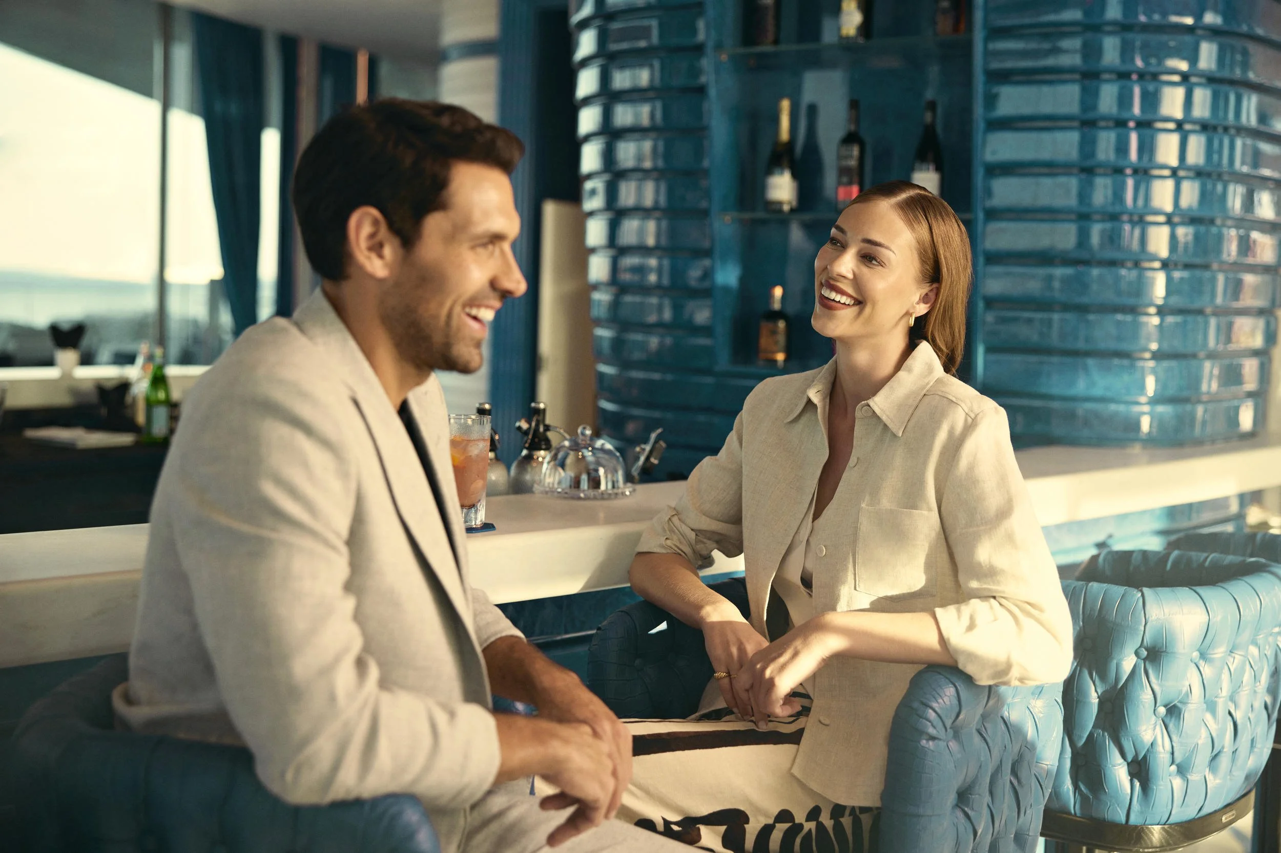 Friend enjoy a drink  at their hotel in this lifestyle image shot for the Saudi Neom project featuring the luxury holiday island Sindalah