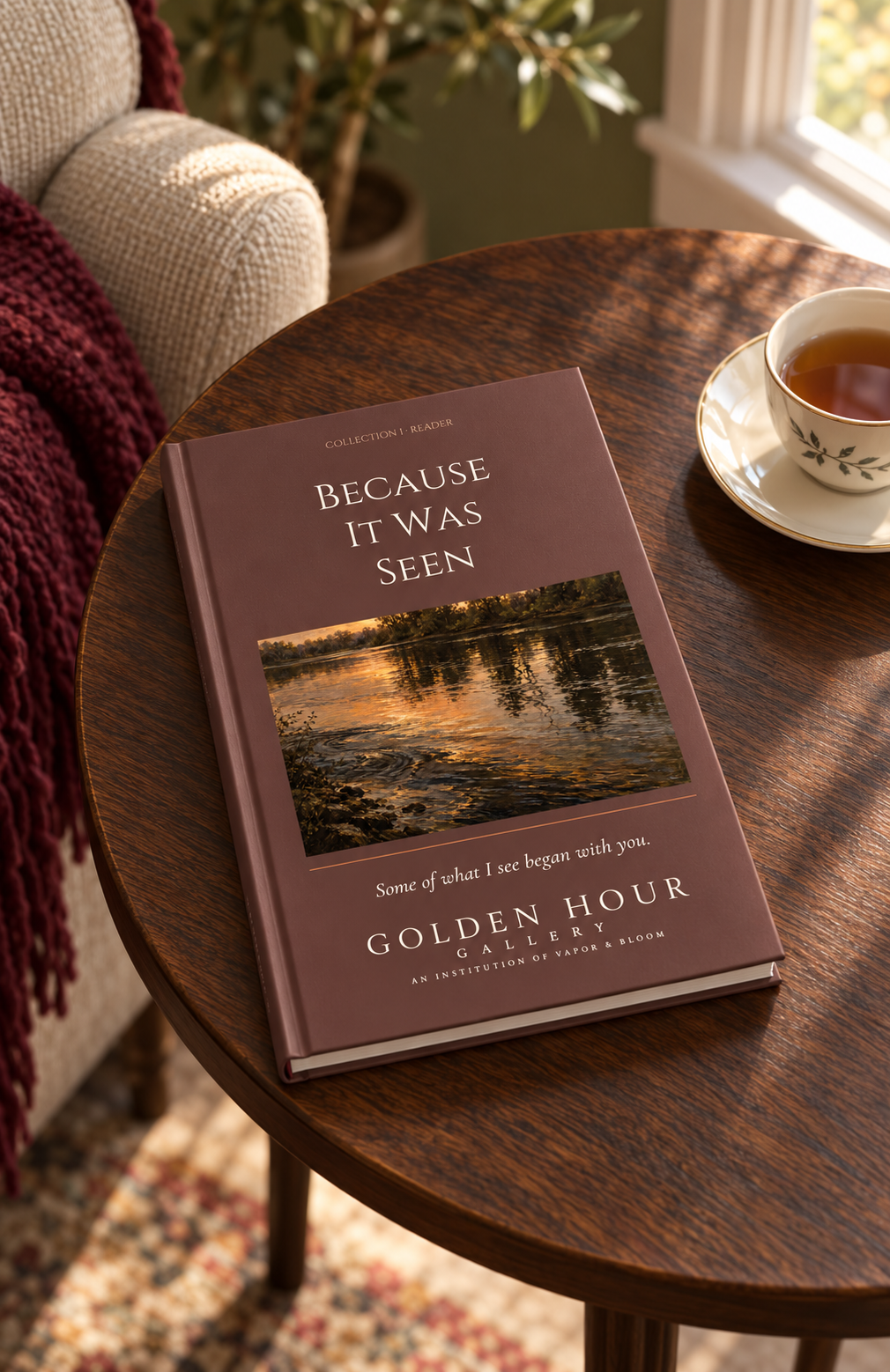 Because It Was Seen hardcover reader with the dark golden-river cover on a table beside a cup of tea.