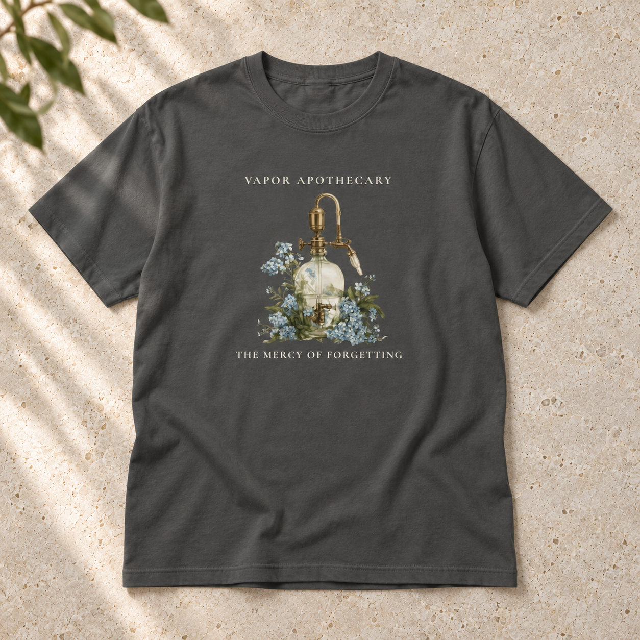 The Mercy of Forgetting T-shirt in Pepper, flat-lay mockup