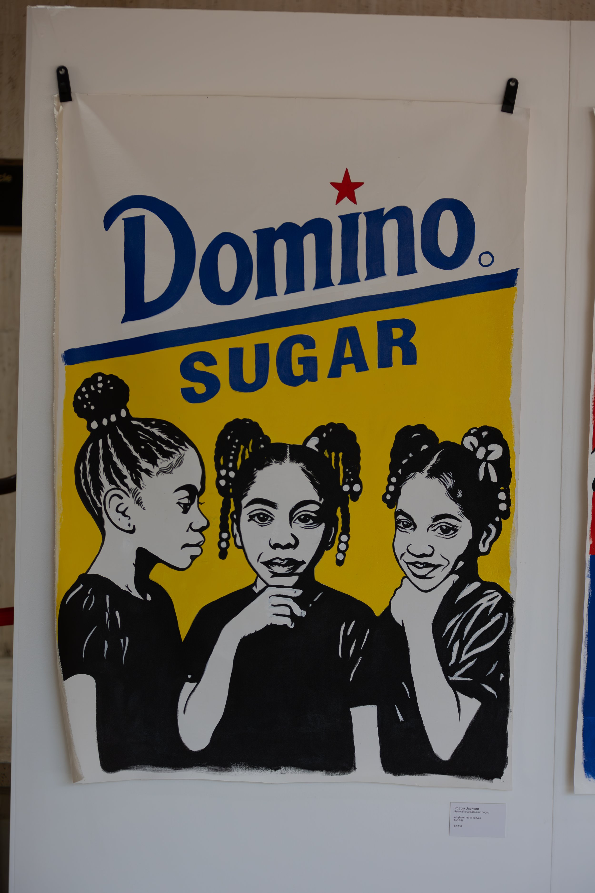 A poster featuring three black-and-white illustrations of women with braided hairstyles on a yellow background. The words 'Domino Sugar' are at the top, with a red star above the letter 'i' and a small black icon of a sugar cube at the bottom left.