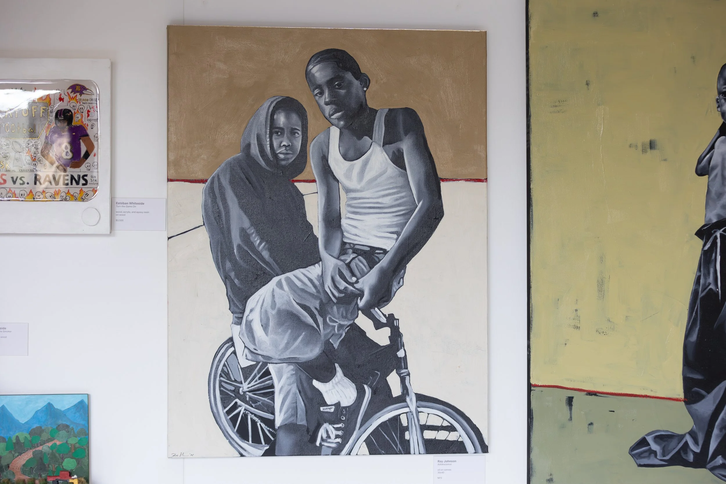 Black and white painting of two young boys, one in a hoodie and the other in a tank top, with one sitting on a wheelchair, against a tan and white background.