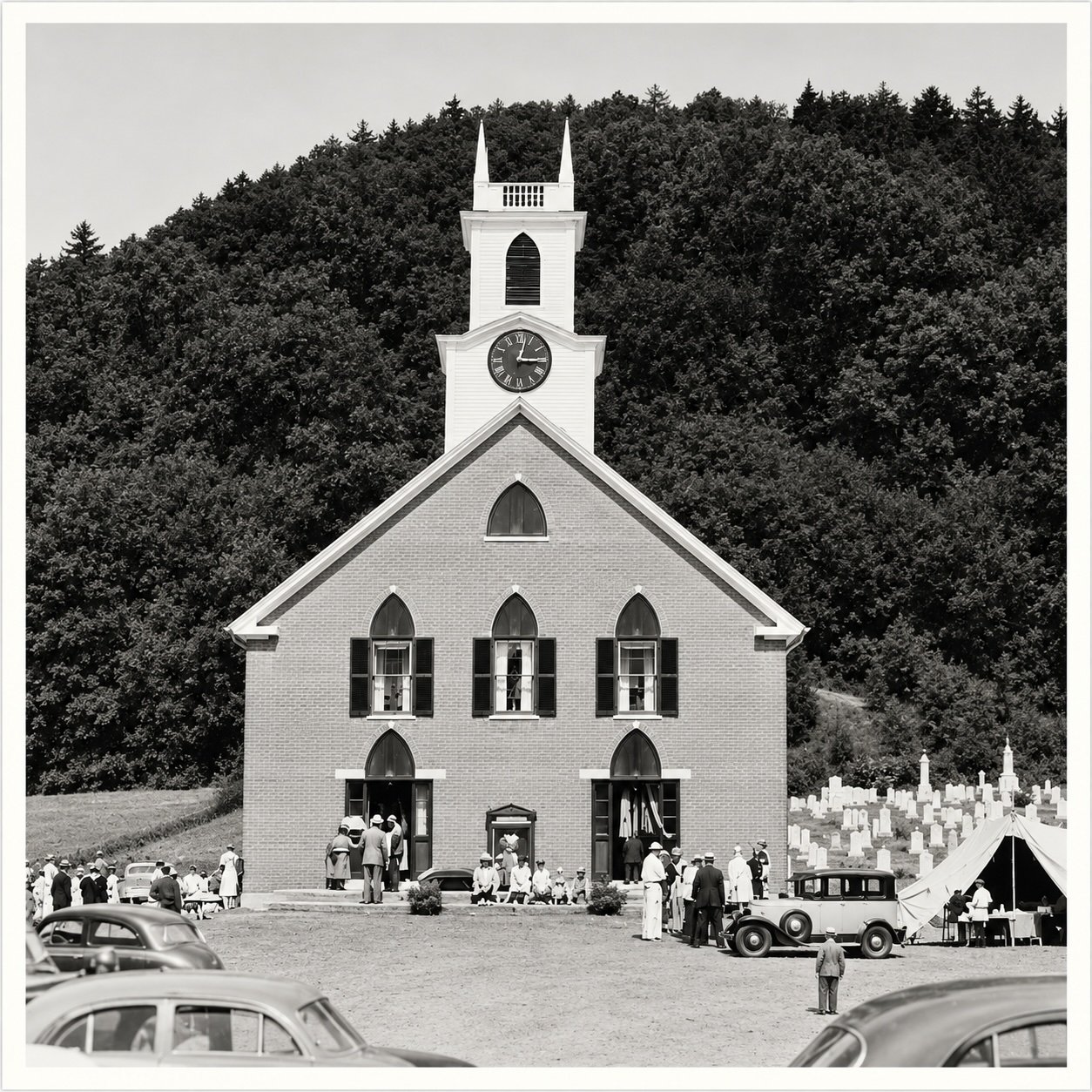 An historic  black and white photo of theTimothy Frost Church in Thetford Center, VT  with a large clock on its steeple, people gathered outside, vintage cars parked nearby, and a tent on the right, with a hillside covered in trees in the background.