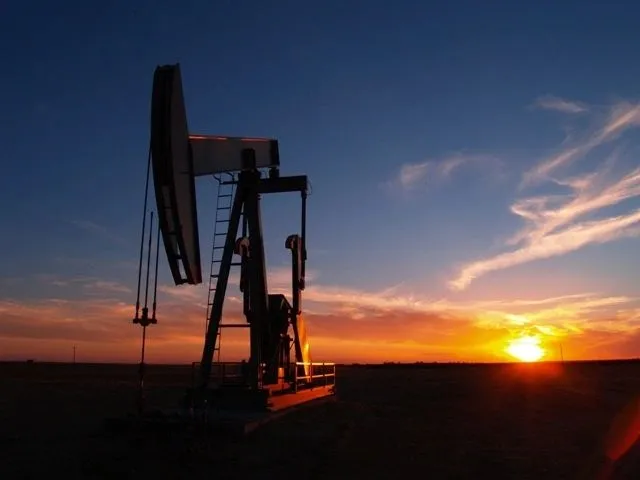 Sunset shot of a lone pump jack in Kansas, captured during a five‑year documentary project on advanced water‑flooding oil recovery techniques.
