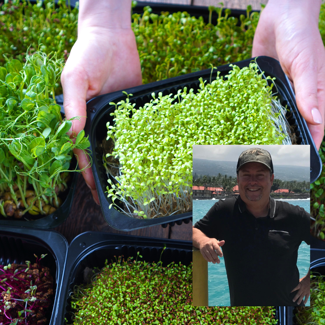 Jeff Evans of Epic Microgreens holding a tray of freshly grown microgreens outdoors.