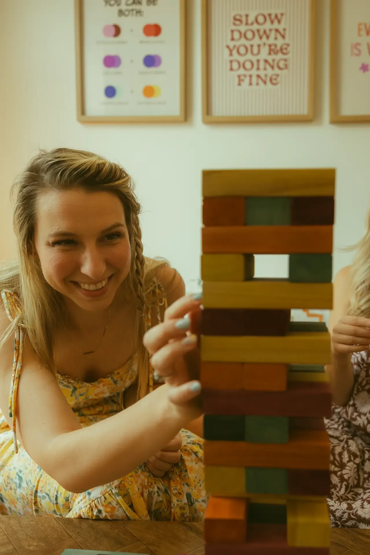 Ohio therapist Bree Ruoff smiling while playing a block-stacking game, a playful way to build coping skills