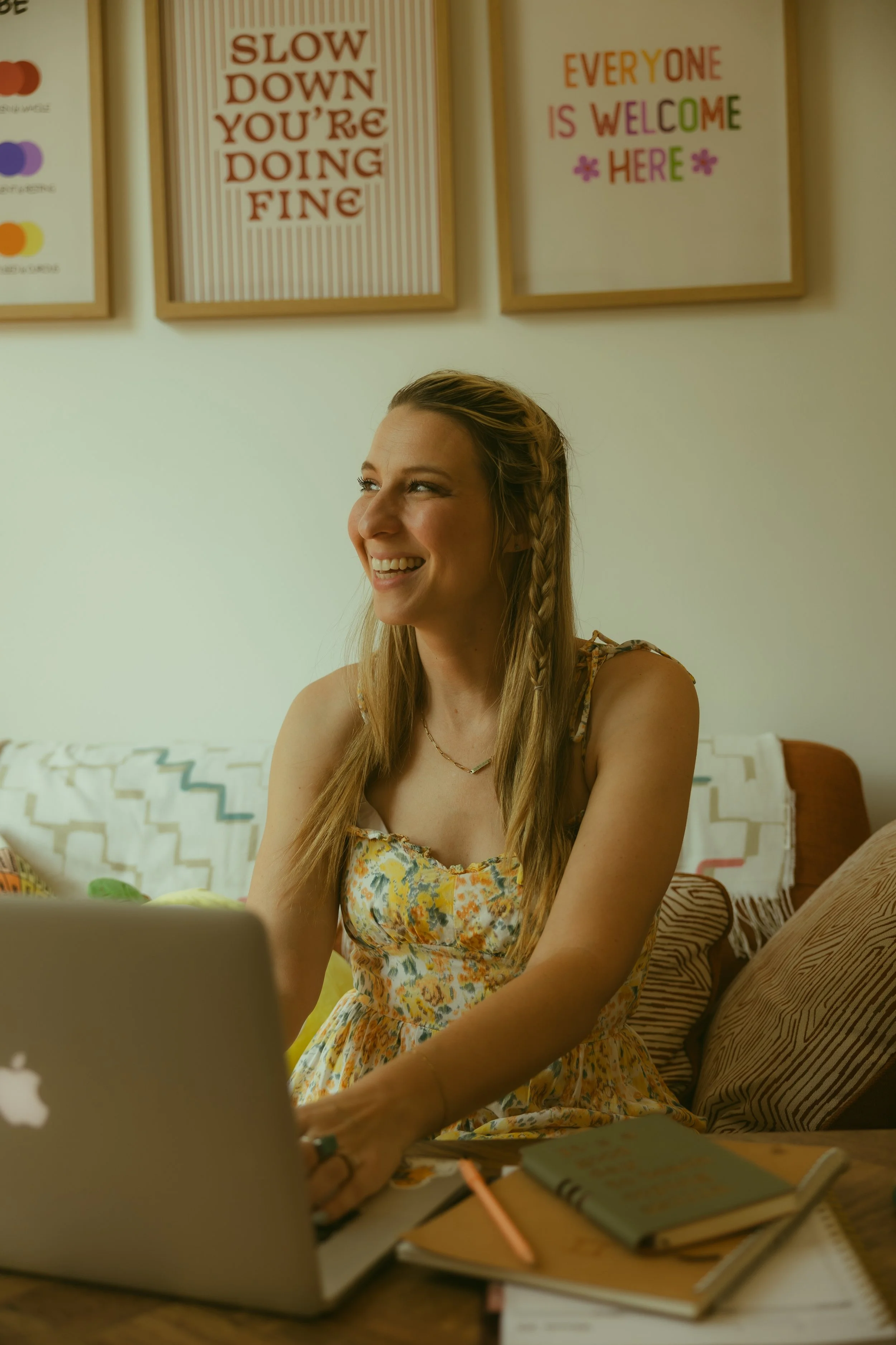 Bree Ruoff smiling at her desk in her online therapy office