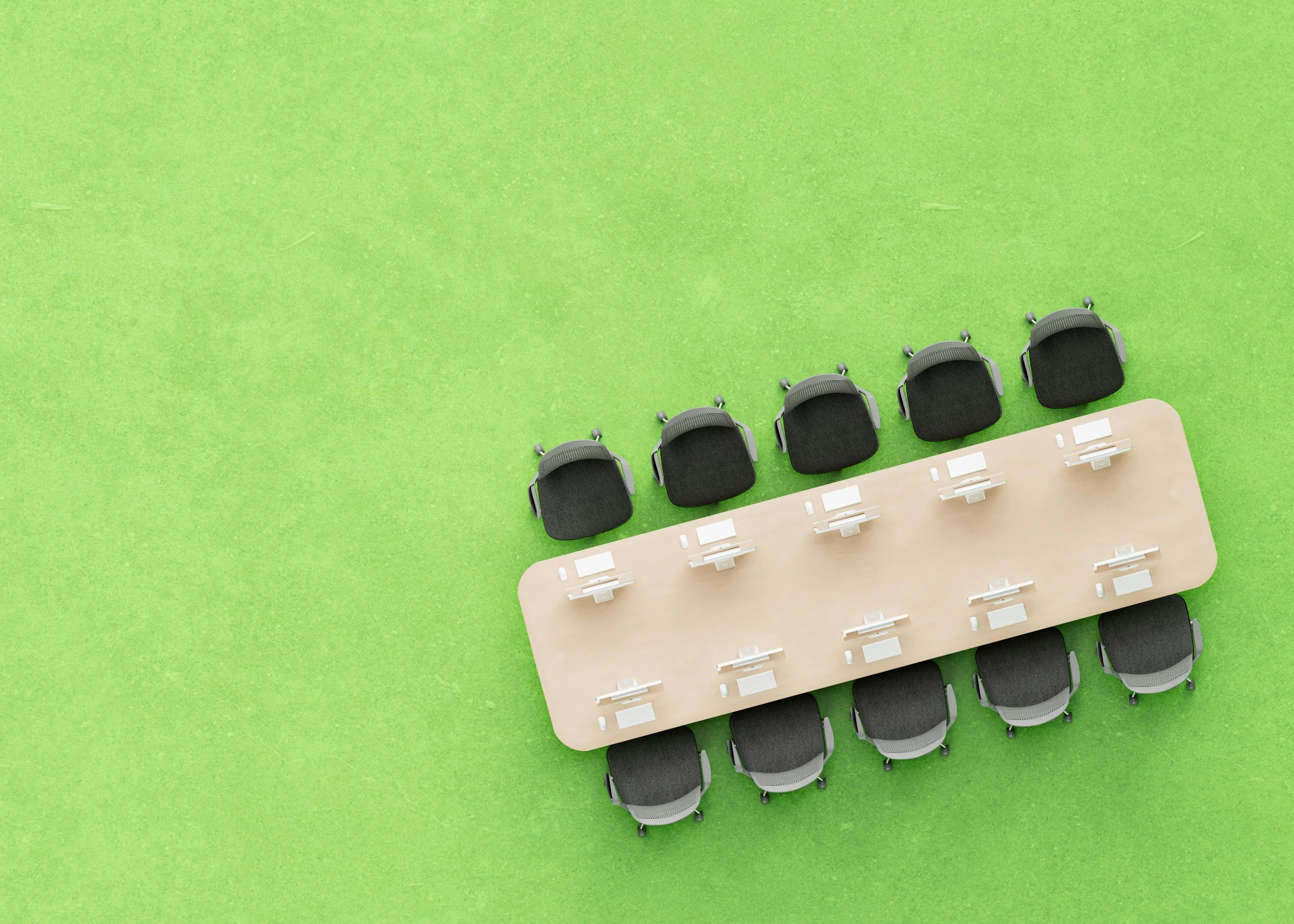 Top-down view of a row of black office chairs at a curved light wood table on green flooring.