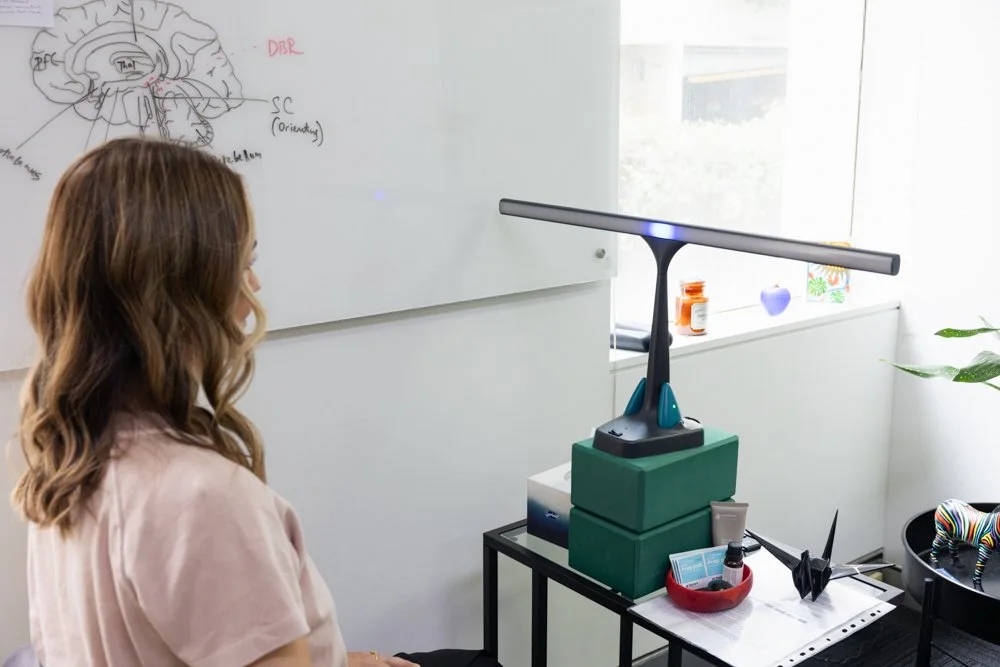 Clinical psychologist Irina Petrova seated at her desk beside a black origami crane.