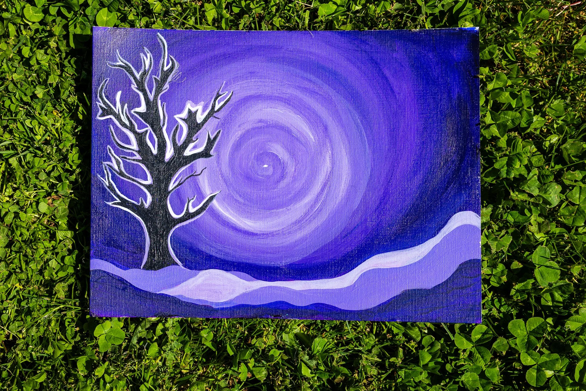 Painting of a leafless tree with white outlines on a purple and blue swirling background, surrounded by green grass.