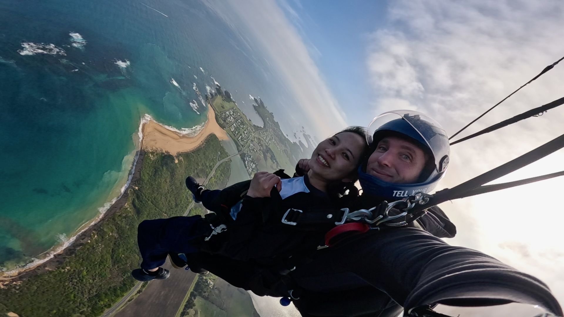 Tandem skydiver and instructor under canopy above the Great Ocean Road coast
