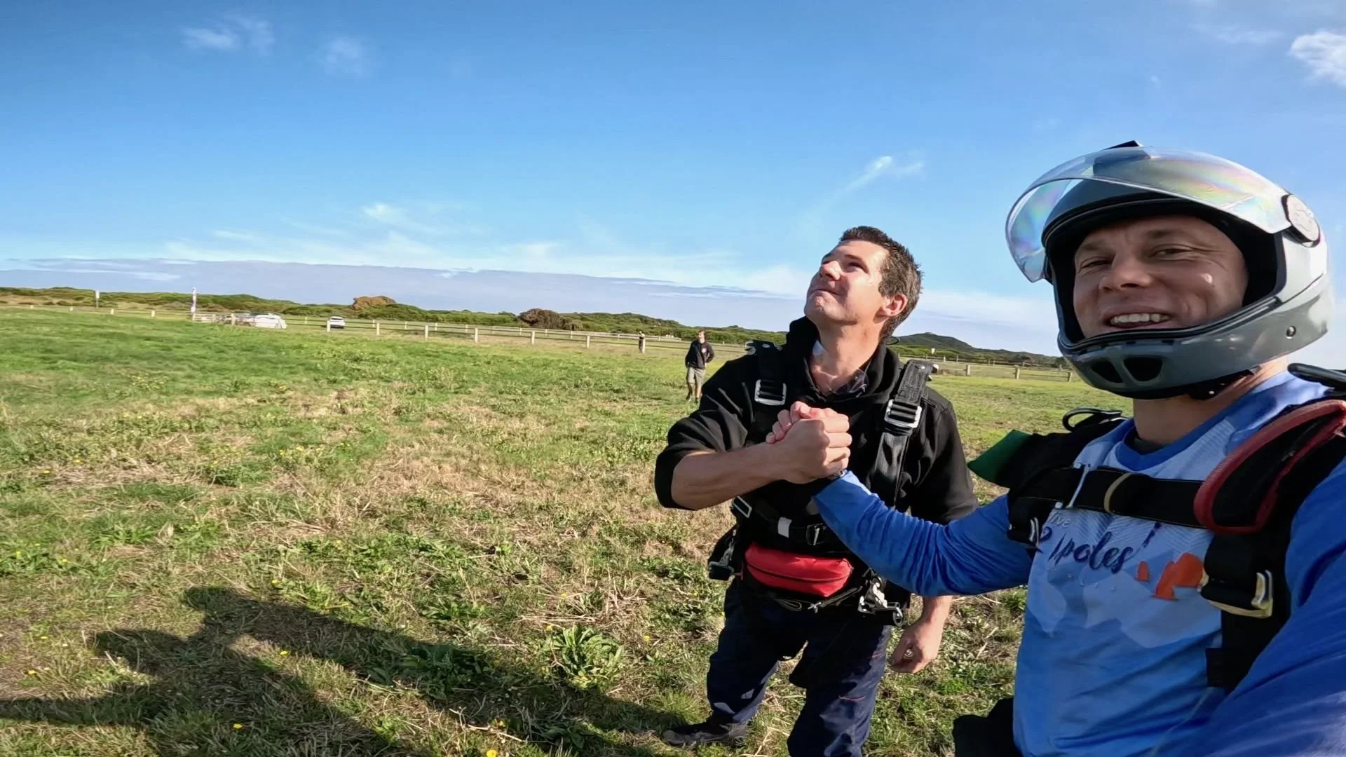 Tandem skydiver celebrating with instructor after landing at Great Ocean Road Airport