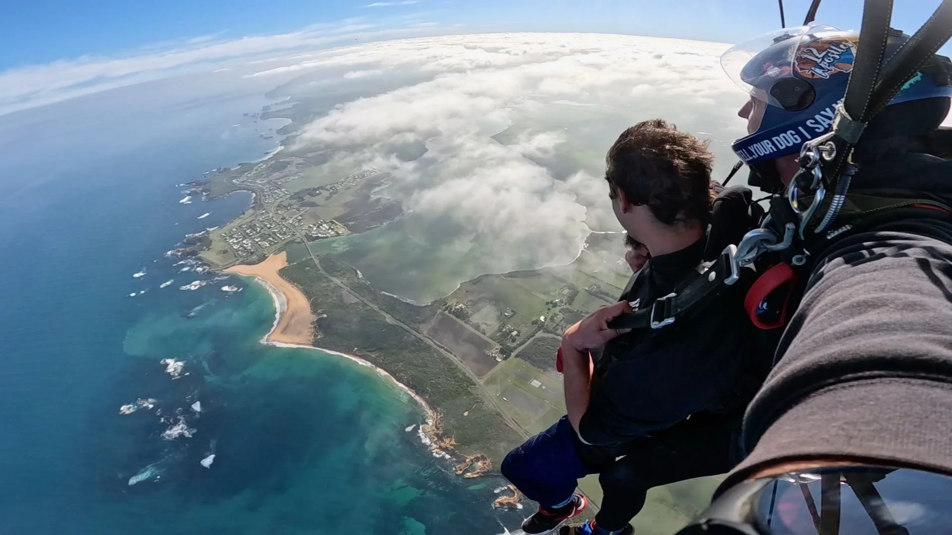 Tandem skydiver under canopy looking over the beach at Peterborough, Victoria