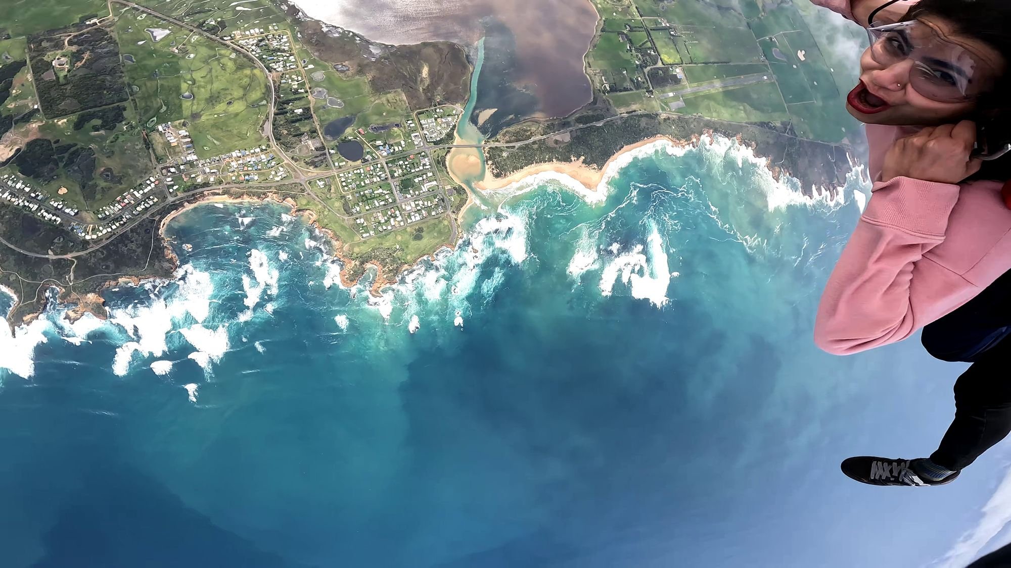 Tandem skydiver in freefall over Peterborough and the Curdies Inlet, Victoria