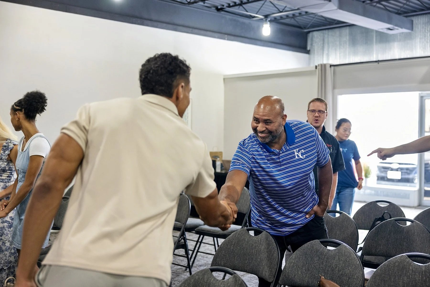 Church attendees greeting one another before a service at Door Church KC.